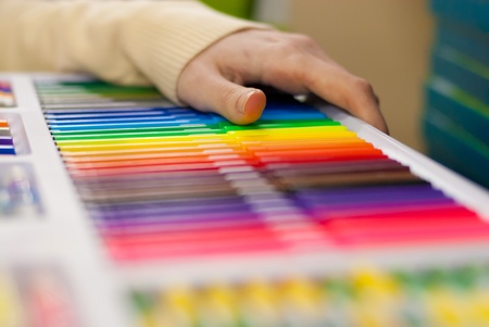 Woman's hand on the shelf selecting markerの写真素材