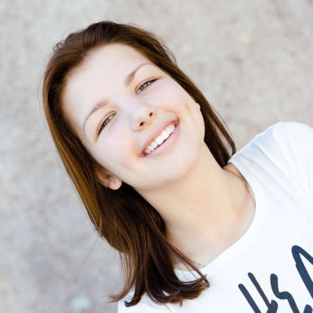 Young happy smiling teenage girl head shot portrait