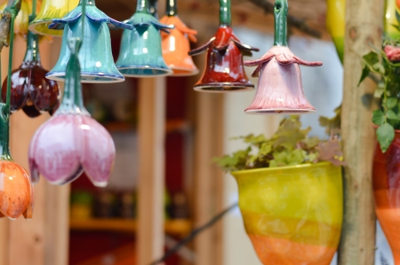 Beautiful colorful ceramic bells in row decoration on marketの写真素材