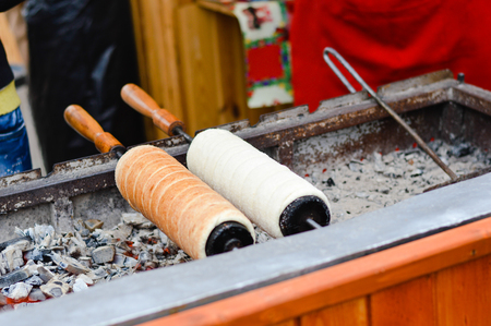 Hungarian Kurtoskalacs prepared on the grill, at a traditional Christmas marketの写真素材