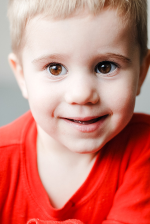 Closeup portrait of little cute boy looking to cameraの写真素材