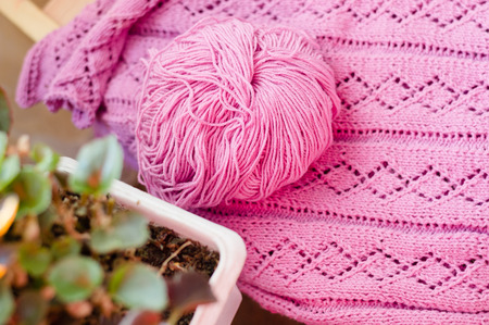 Detail of woven handicraft knit woolen design texture and clew  Fabric pink backgroundの写真素材