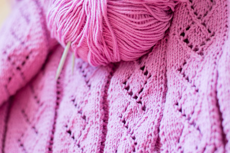 Detail of woven handicraft knit woolen design texture and clew  Fabric pink background