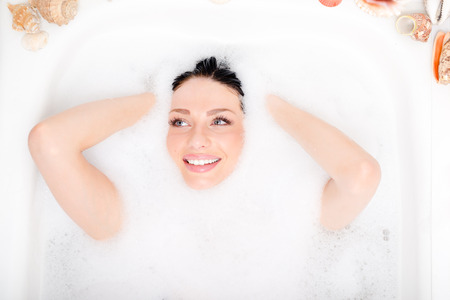 beautiful blue eyes brunette girl attractive young sexy woman relaxing plunged into the foam and...