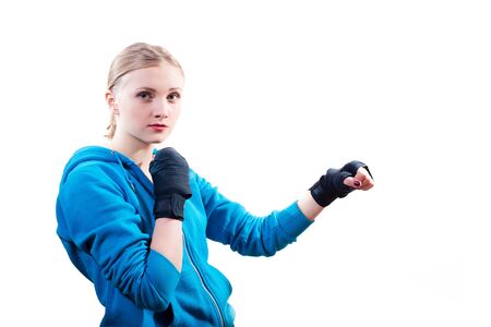 Picture of attractive blond teenage girl in sportswear and gloves streaching arms isolated copyspace half length portraitの写真素材