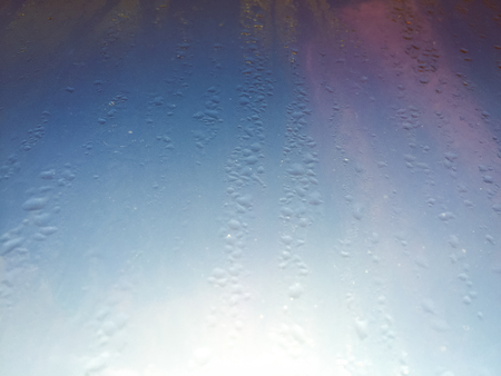 Rain drops on window on moody day background