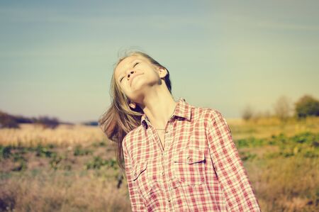Positive attractive blonde girl on outdoors background, portraitの写真素材