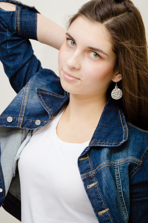 Young attractive caucasian stylish woman wearing blue jeans jacket on studio background. Closeup portrait, trendy lifestyleの写真素材