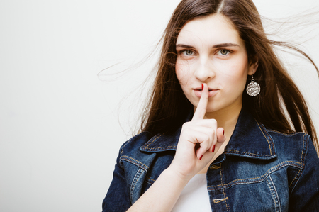 Young attractive caucasian stylish woman wearing blue jeans jacket on studio background. Closeup portrait, trendy lifestyleの写真素材
