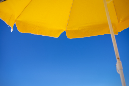 Beach umbrellas and blue sky outdoors backgroundの写真素材