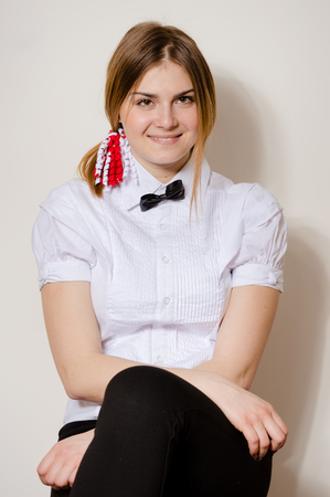 Portrait of attractive student happy joyful looking at camera on light wall background. Close up photographyの写真素材