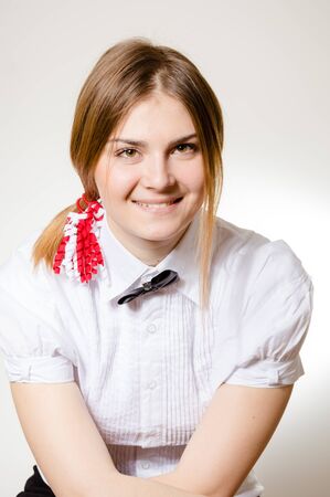 Portrait of attractive student happy joyful looking at camera on light wall background. Close up photographyの写真素材