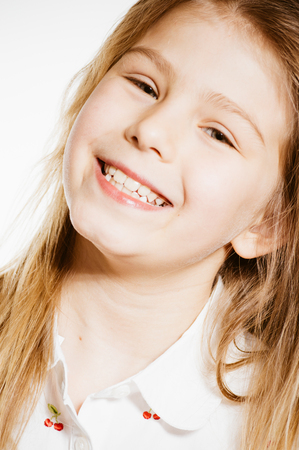 Joyful exciting girl on a light background, closeup portraitの写真素材