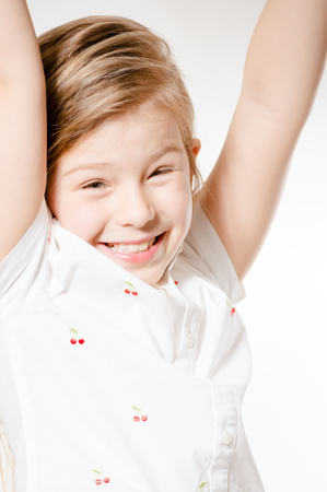 Joyful exciting girl on a light background, closeup portraitの写真素材