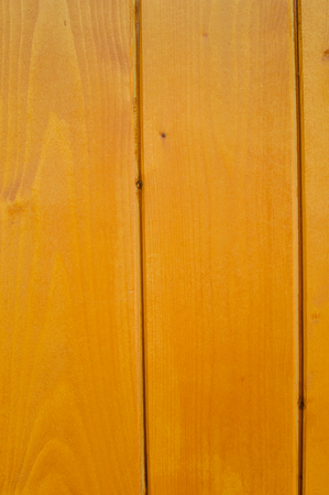 Golden wood detail background. Close up photo of natural pine planks textured surface, architectural abstractionの写真素材