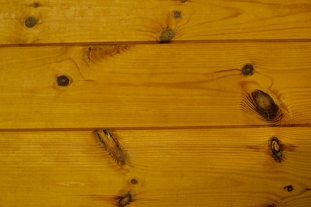 Golden wood detail background. Close up photo of natural pine planks textured surface, architectural abstractionの写真素材