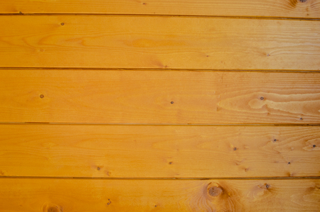 Golden wood detail background. Close up photo of natural pine planks textured surface, architectural abstractionの写真素材