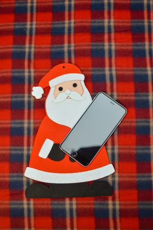Antwerp, Belgium - 6 December, 2017: Closeup on Santa Claus using Apple iPhone 8 smartphone. Digital social network mock up photography. Modern internet wireless technology, happy festive joyful timeのeditorial素材