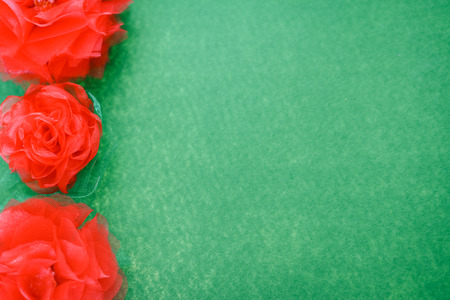 Closeup top view of beautiful flowers handmade fabric on green flat lay textured bright backgroundの写真素材