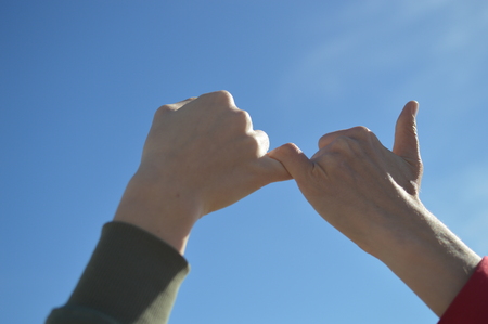 Touching human hands of cheerful people on sunshine beautiful nature outdoors. Lovely valentine harmony, symbolic friendship help. Closeup lifestyle support, dreams holiday travel freedom vacationの写真素材