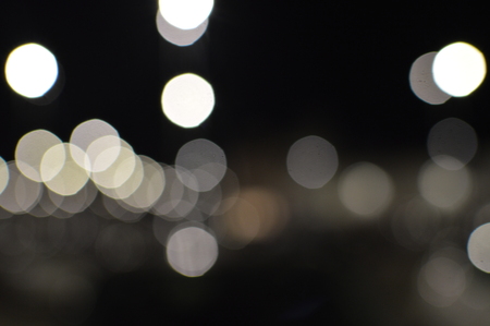 Night bokeh shiny glowing lights city street outdoors, blurred effect abstraction image backgroundの写真素材
