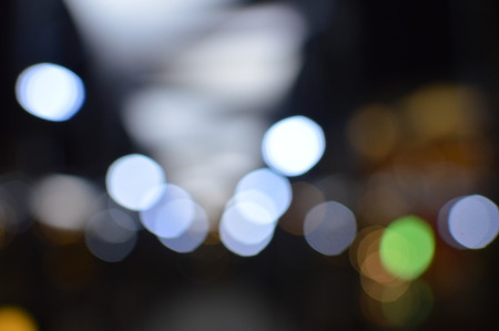 Night bokeh shiny glowing lights city street outdoors, blurred effect abstraction image backgroundの写真素材