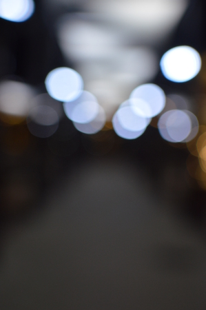 Night bokeh shiny glowing lights city street outdoors, blurred effect abstraction image backgroundの写真素材
