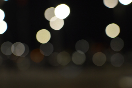 Night bokeh shiny glowing lights city street outdoors, blurred effect abstraction image backgroundの写真素材