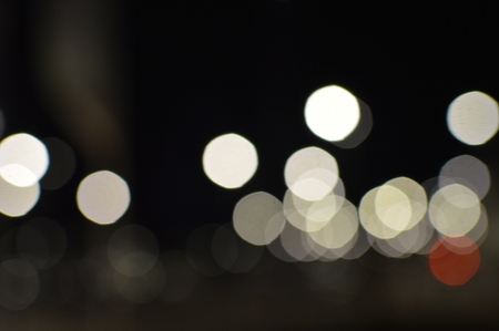 Night bokeh shiny glowing lights city street outdoors, blurred effect abstraction image backgroundの写真素材