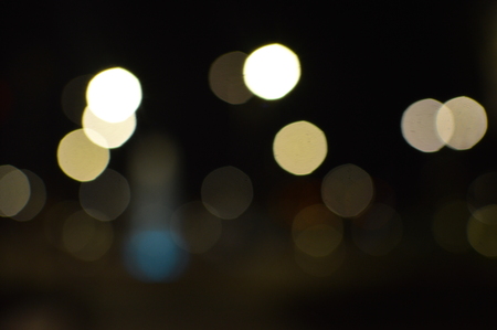 Night bokeh shiny glowing lights city street outdoors, blurred effect abstraction image backgroundの写真素材