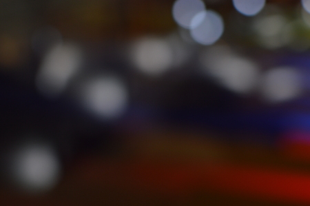 Night bokeh shiny glowing lights city street outdoors, blurred effect abstraction image backgroundの写真素材