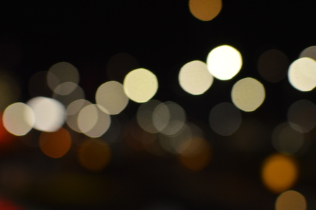 Night bokeh shiny glowing lights city street outdoors, blurred effect abstraction image backgroundの写真素材
