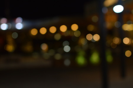 Night bokeh shiny glowing lights city street outdoors, blurred effect abstraction image backgroundの写真素材