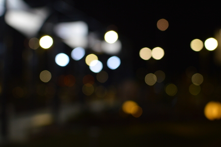 Night bokeh shiny glowing lights city street outdoors, blurred effect abstraction image backgroundの写真素材