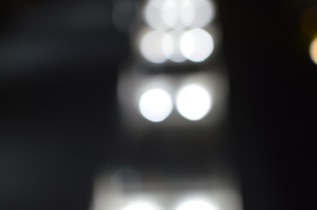 Night bokeh shiny glowing lights city street outdoors, blurred effect abstraction image backgroundの写真素材