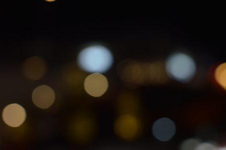 Night bokeh shiny glowing lights city street outdoors, blurred effect abstraction image backgroundの写真素材