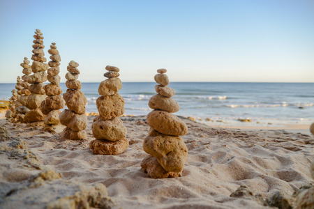 Stones balance on beach, sunset shotの写真素材