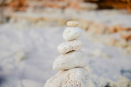 Stones balance on beach, sunset shotの写真素材
