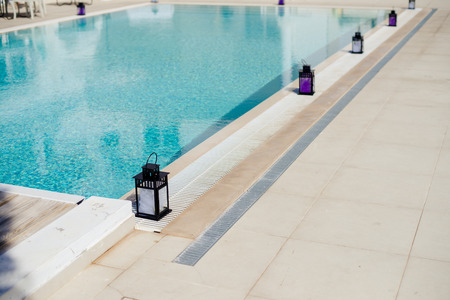 Candle lantern near the pools edge on a summers day, Portugalの写真素材