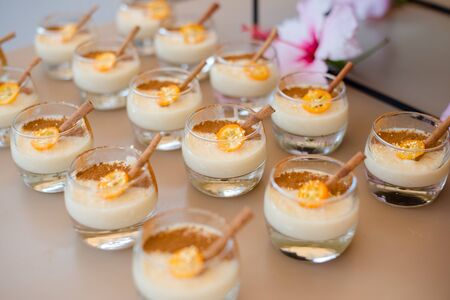 The catering wedding buffet for events. Wedding reception dessert table with delicious decorated white cupcakes with berries closeup.の写真素材
