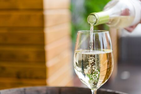Pouring a glass of white wine closeupの写真素材