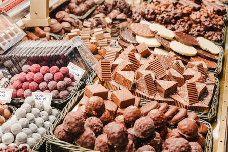 A selection of various delicious chocolate deserts for sale at a market stall