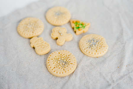 Traditional almond cookie with sugar, spices, and vintage rolling pin on rustic, on natural linen background. Top view still life with natural light.の写真素材