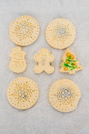 Traditional almond cookie with sugar, spices, and vintage rolling pin on rustic, on natural linen background. Top view still life with natural light.の写真素材