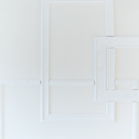 White wooden trendy decor on the white wall backdrop. Artistic background that can be used for design cover, poster, brochure and etc.の写真素材
