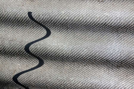 Abstract composition on a background sheet ribbed slate