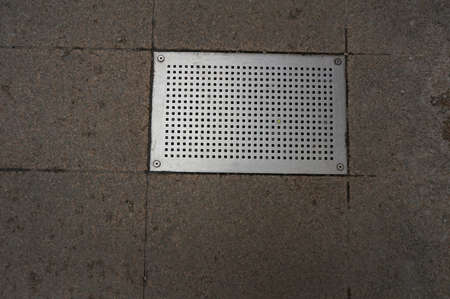 Rectangular metal grating of street drainage system