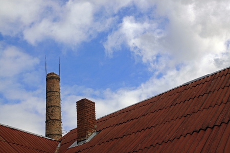 Large brick chimney on the background of the bright skyの写真素材