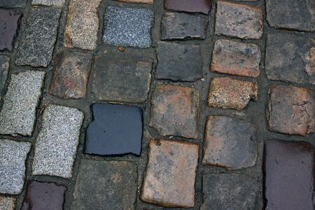 Close-up of the old cobblestones in dark colors