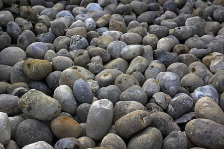 Gray oval stones with endless perspective background. Selective focus